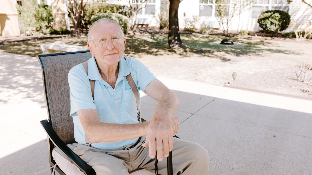 Elder sitting outside at Courtyard Rehabilitation and Health Center